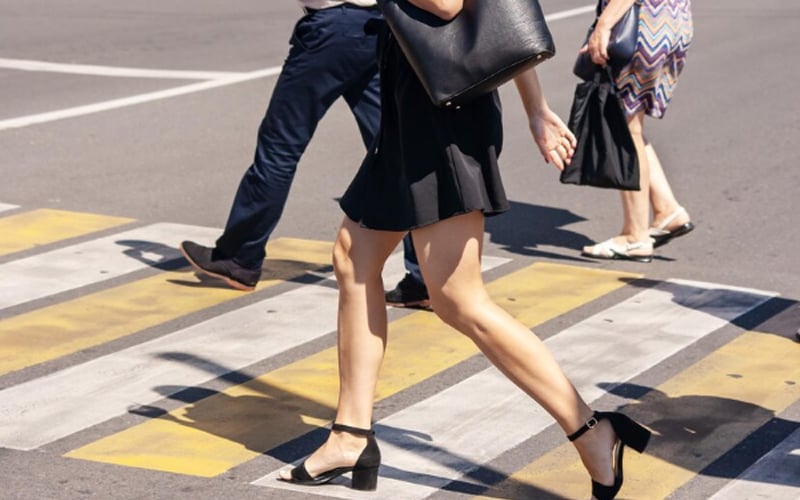woman walking on the road wearing sandals