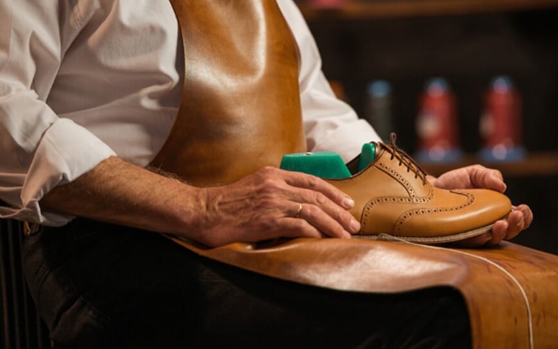 a mature shoemaker in the workshop making shoes