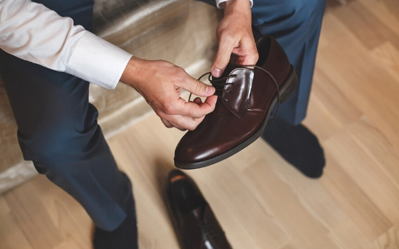 a man treating his shoes carefully