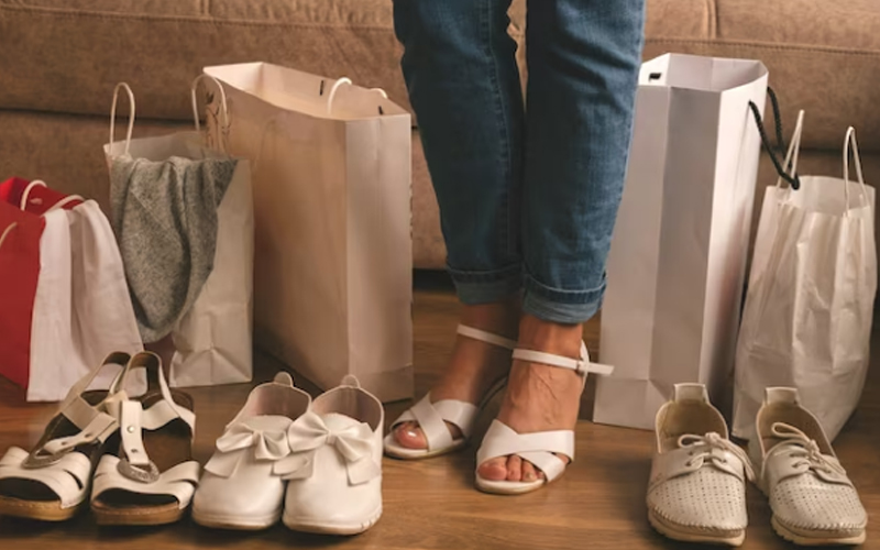a woman buying shoes of different styles