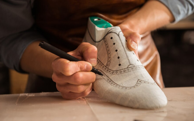 a male shoemaker drawing design