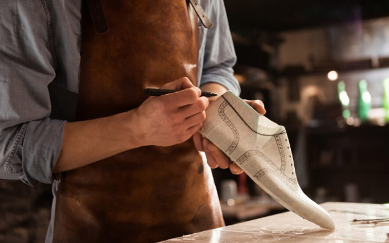 a male shoemaker drawing design