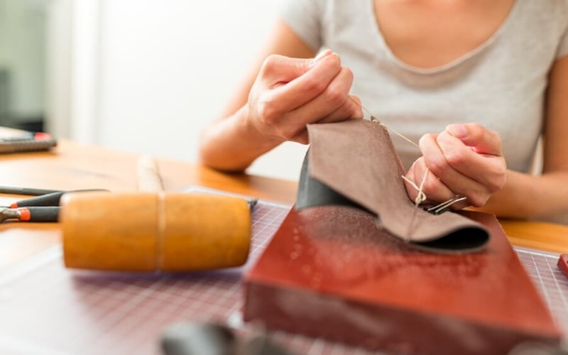 a woman making shoes